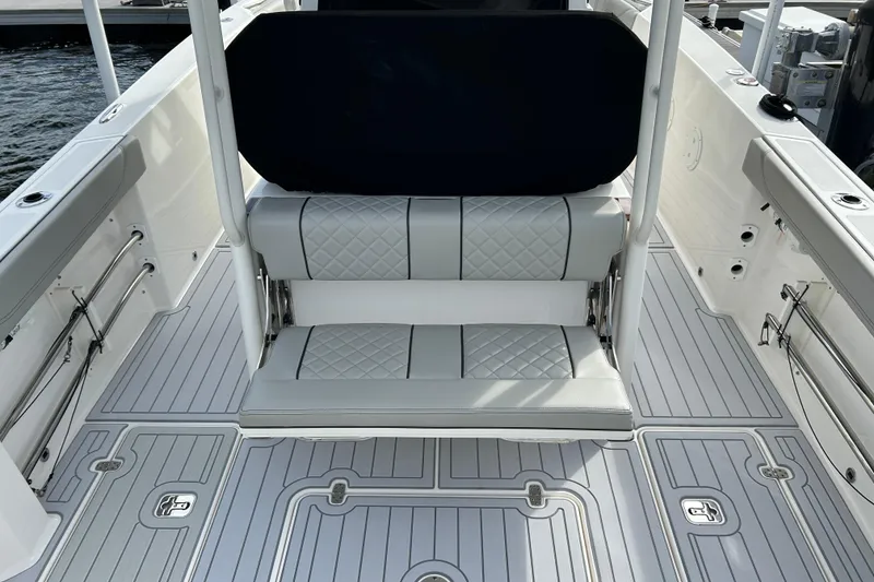 Slide: The Image of 2023 Pursuit S 288 Sport boat interior with cushioned seating and sleek flooring design. - 24