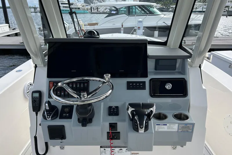 Slide: The Image of 2023 Pursuit S 288 Sport boat dashboard with steering wheel and controls. - 26