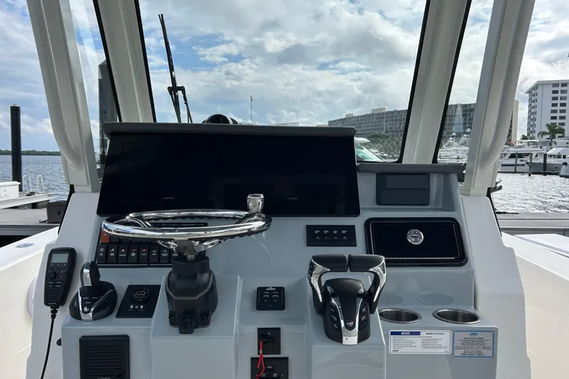 Slide: The Image of 2023 Pursuit S 288 Sport boat dashboard with steering wheel and controls. - 27