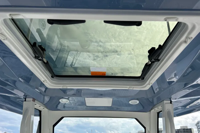 Slide: The Image of 2023 Pursuit S 288 Sport boat's sunroof view with blue sky reflection. - 31
