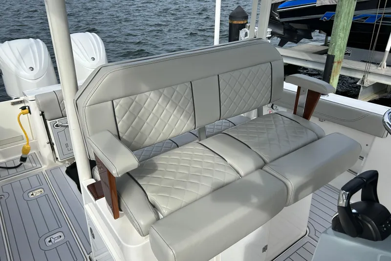 Slide: The Image of 2023 Pursuit S 288 Sport boat with luxurious quilted seating and dual outboard motors. - 33
