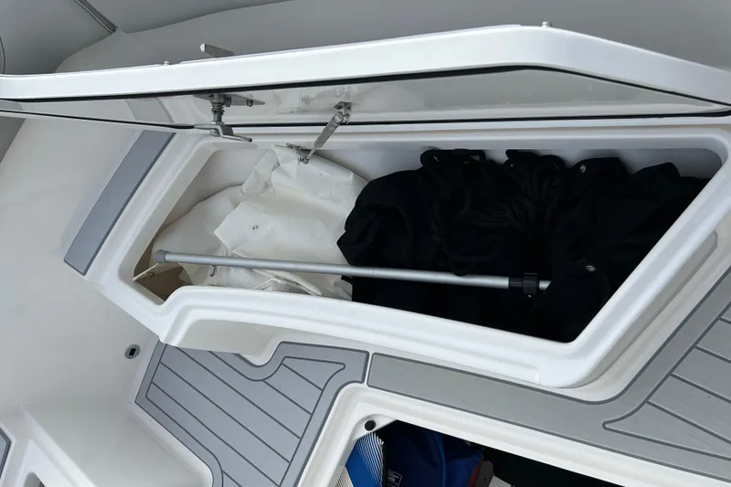 Slide: The Image of 2023 Pursuit S 288 Sport boat storage compartment with gear and equipment. - 42