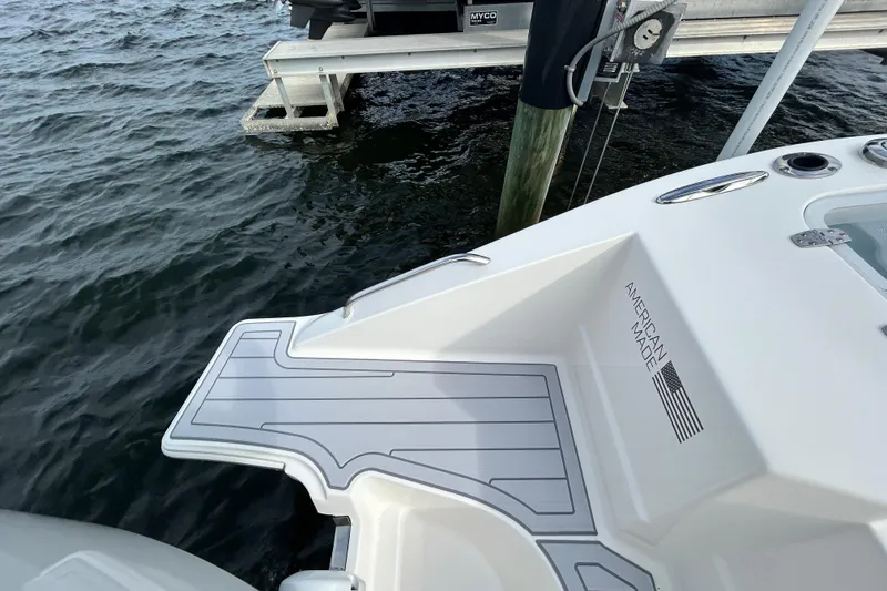 Slide: The Image of 2023 Pursuit S 288 Sport boat with "American Made" label, docked by the water. - 8