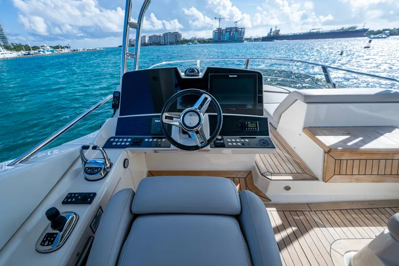 Slide: The Image of 2018 Sea Ray L550 Fly yacht helm with modern controls and ocean view. - 11