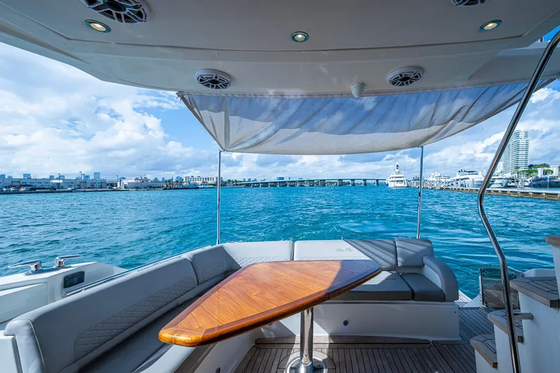 Slide: The Image of Luxurious 2018 Sea Ray L550 Fly yacht interior with ocean view and elegant seating area. - 13