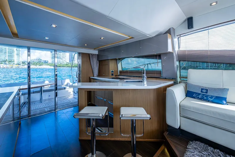 Slide: The Image of Luxurious interior of 2018 Sea Ray L550 Fly yacht with modern kitchen and waterfront view. - 22