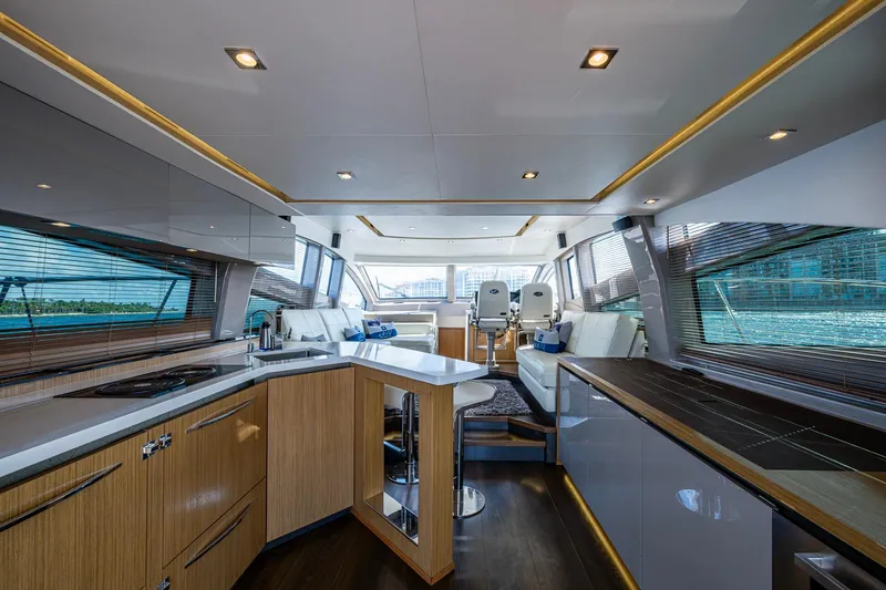 Slide: The Image of Luxurious interior of 2018 Sea Ray L550 Fly yacht with modern kitchen and seating area. - 23