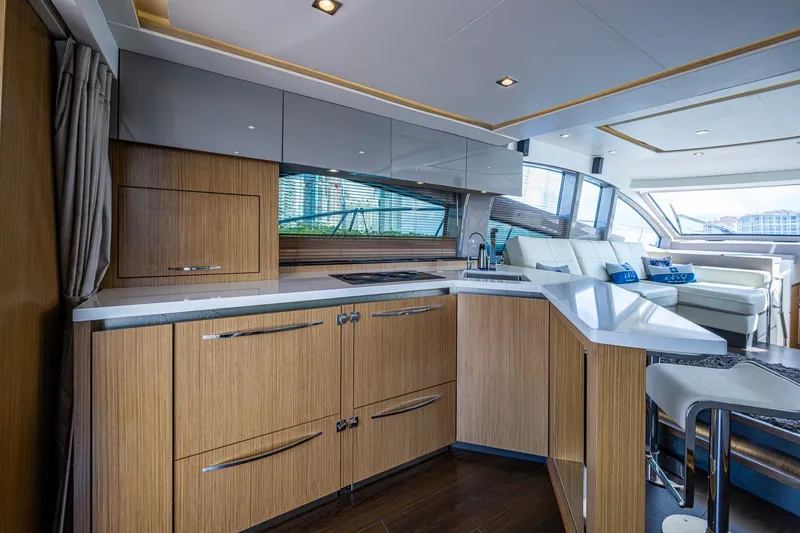 Slide: The Image of Luxurious interior of 2018 Sea Ray L550 Fly yacht with modern kitchen and seating area. - 24
