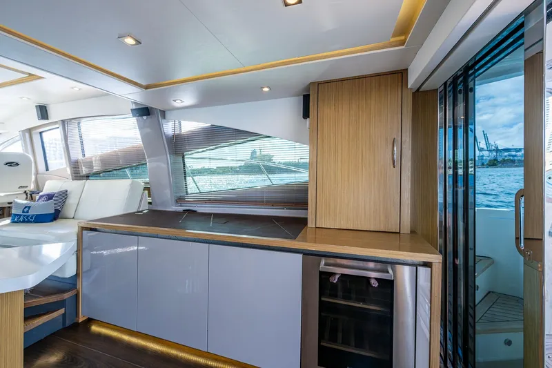 Slide: The Image of Luxurious interior of 2018 Sea Ray L550 Fly yacht with modern cabinetry and scenic water view. - 25