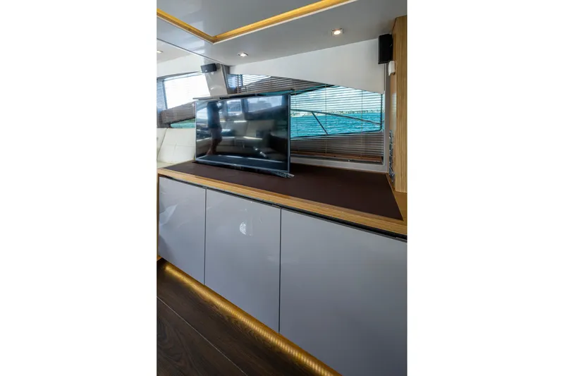 Slide: The Image of Luxurious interior of 2018 Sea Ray L550 Fly yacht with modern TV and sleek cabinetry. - 26