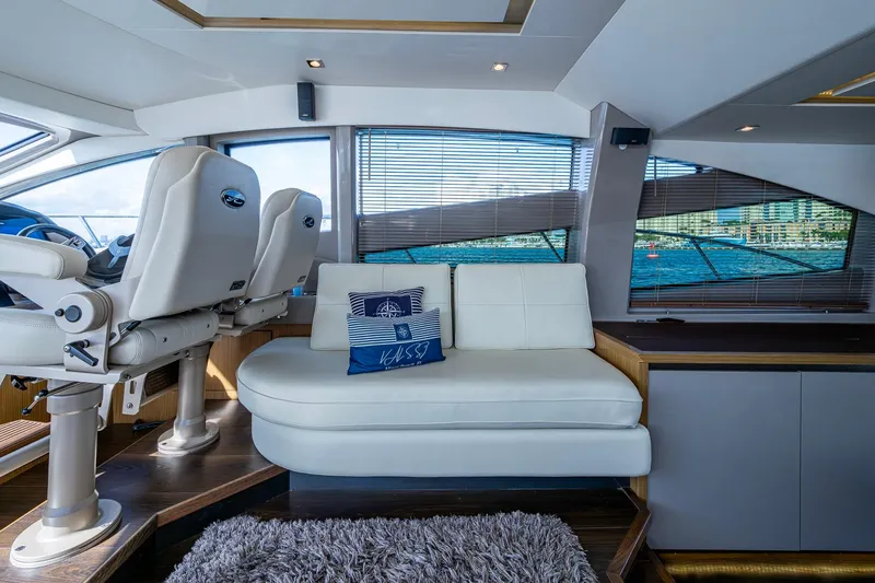Slide: The Image of Luxurious interior of 2018 Sea Ray L550 Fly yacht with plush seating and scenic window views. - 32