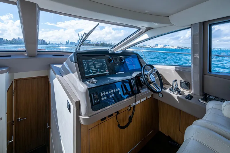 Slide: The Image of 2018 Sea Ray L550 Fly yacht helm with modern navigation controls and ocean view. - 34