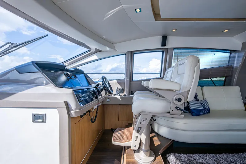 Slide: The Image of 2018 Sea Ray L550 Fly yacht interior with modern helm and luxurious seating. - 35