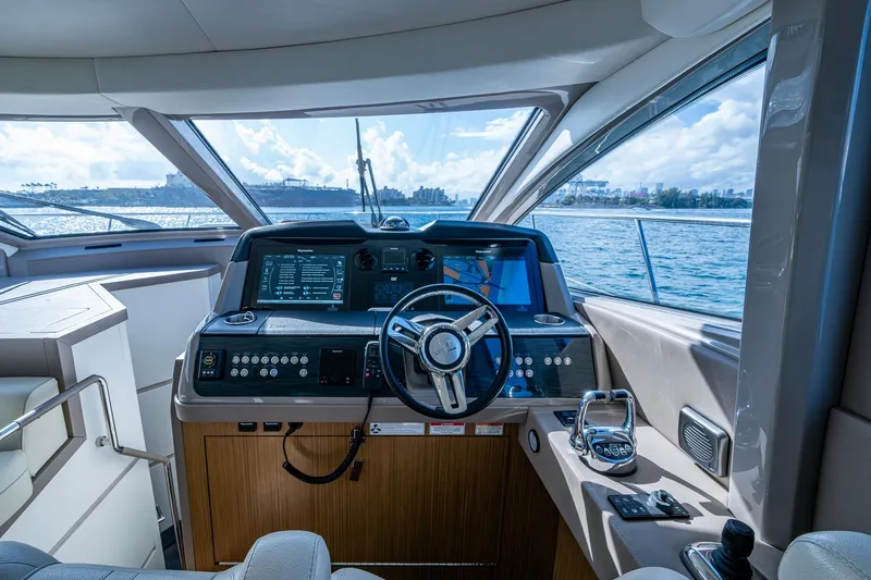 Slide: The Image of 2018 Sea Ray L550 Fly yacht helm with modern navigation controls and ocean view. - 36