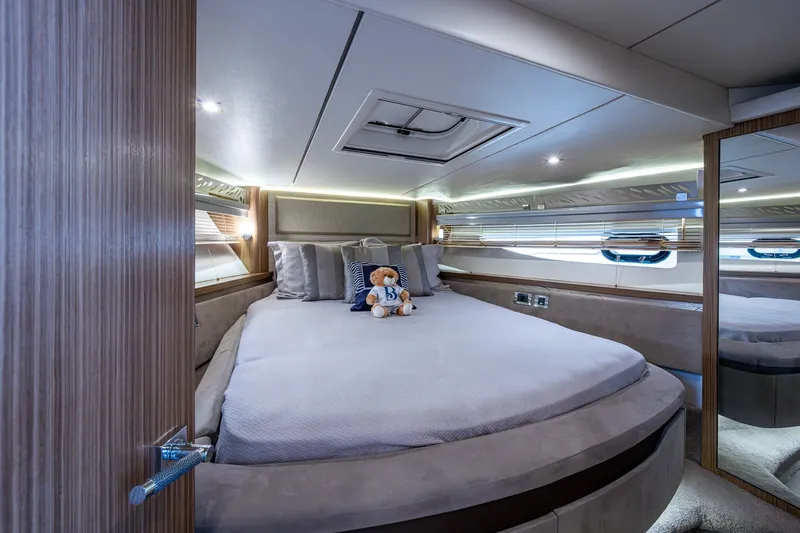 Slide: The Image of Luxurious 2018 Sea Ray L550 Fly yacht bedroom with plush bedding and elegant decor. - 44
