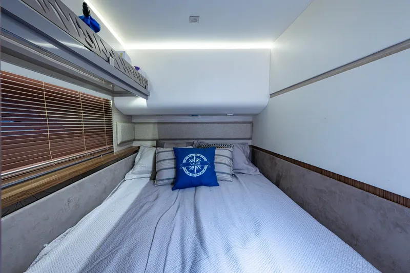 Slide: The Image of Luxurious bedroom interior of 2018 Sea Ray L550 Fly yacht with nautical-themed decor. - 48