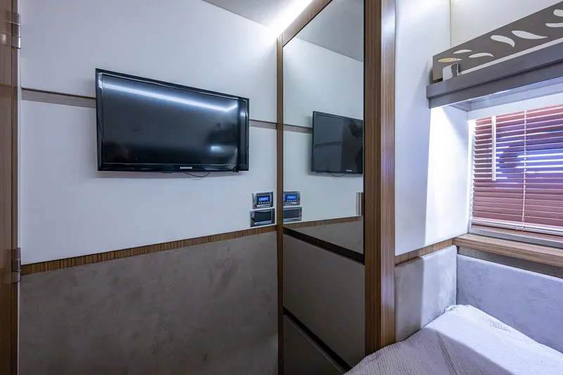 Slide: The Image of Luxurious 2018 Sea Ray L550 Fly cabin interior with TV and modern decor. - 49