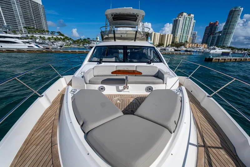 Slide: The Image of 2018 Sea Ray L550 Fly yacht with luxurious deck, docked in a vibrant marina. - 5