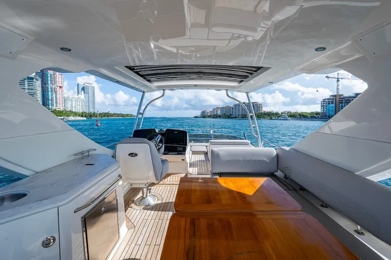 Slide: The Image of Luxurious 2018 Sea Ray L550 Fly yacht interior with ocean view and city skyline. - 8