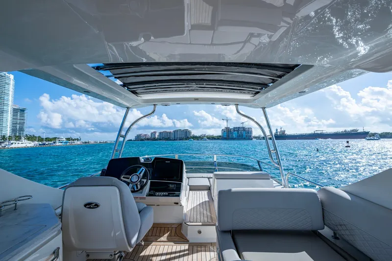 Slide: The Image of Luxurious 2018 Sea Ray L550 Fly yacht interior with ocean view and modern helm. - 9