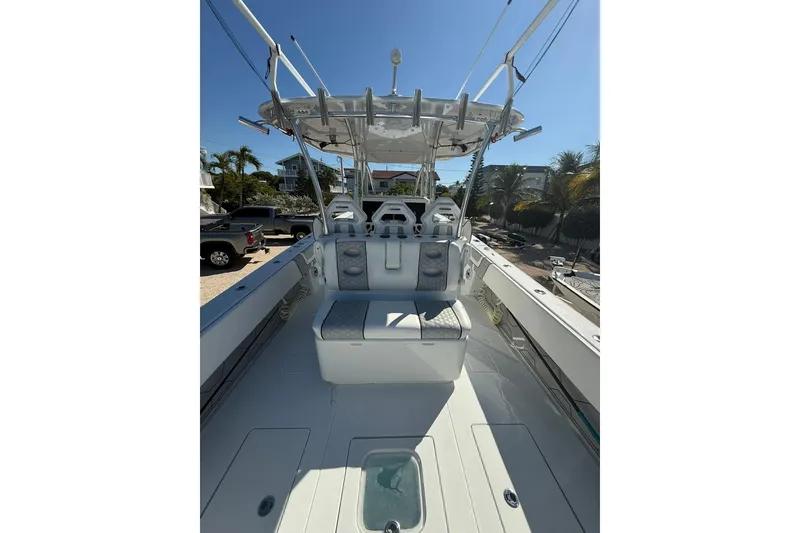 Slide: The Image of 2022 Contender 39 ST boat interior with seating and helm, under clear blue sky. - 11