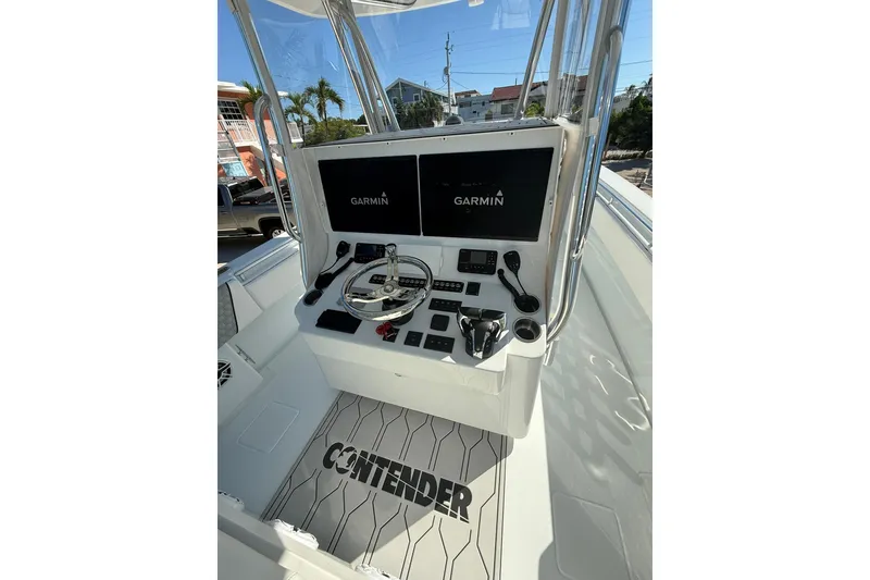 Slide: The Image of 2022 Contender 39 ST boat console with Garmin displays and steering wheel. - 12