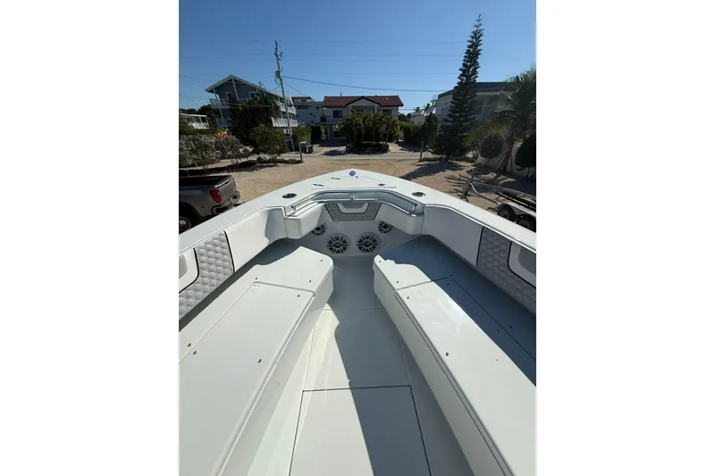 Slide: The Image of 2022 Contender 39 ST boat interior with seating and speakers, parked in a residential area. - 14