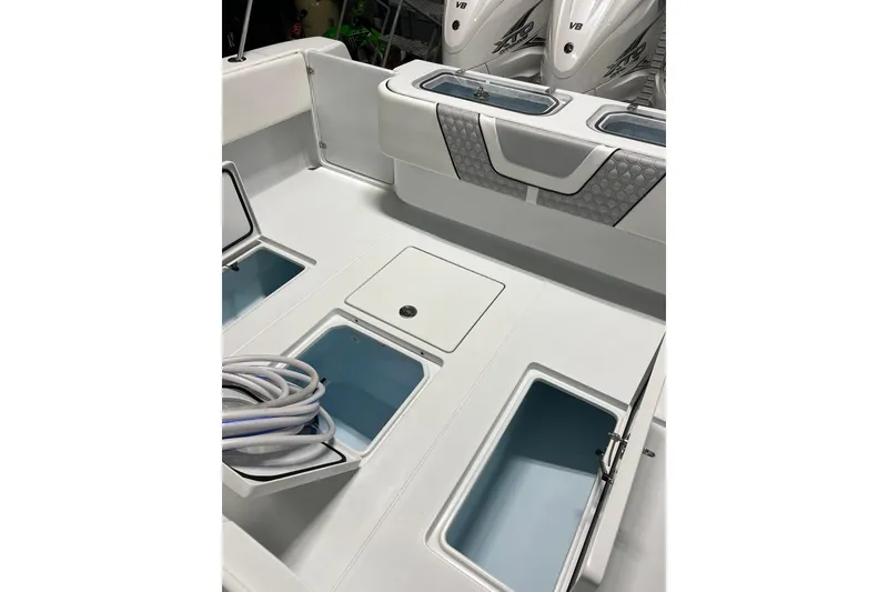 Slide: The Image of 2022 Contender 39 ST boat deck with storage compartments and coiled rope. - 18