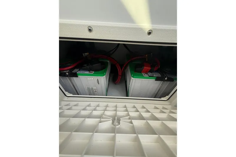 Slide: The Image of Battery compartment of 2022 Contender 39 ST boat with visible wiring. - 22