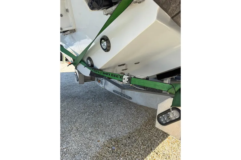 Slide: The Image of 2022 Contender 39 ST boat secured with green straps on a trailer. - 26