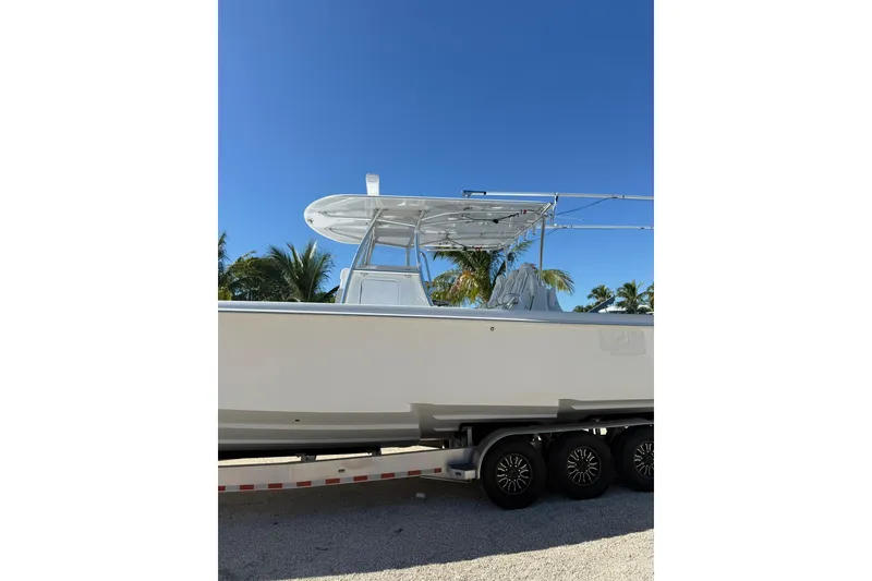 Slide: The Image of 2022 Contender 39 ST boat on trailer under clear blue sky. - 7