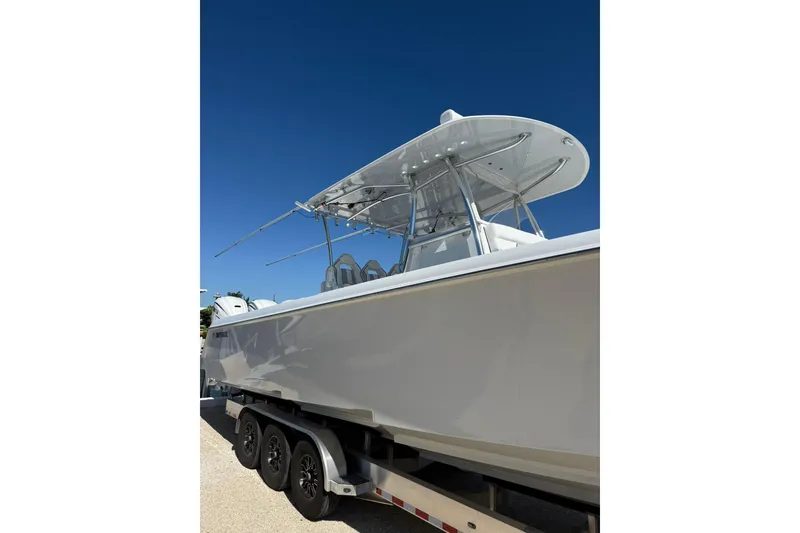 Slide: The Image of 2022 Contender 39 ST boat on trailer under clear blue sky. - 8