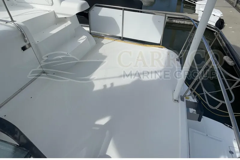 Slide: The Image of 1996 Cruisers Yachts 3650 Aft Cabin deck with stairs and railing at marina. - 13