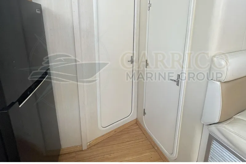 Slide: The Image of Interior of 1996 Cruisers Yachts 3650 Aft Cabin with white doors and seating. - 28