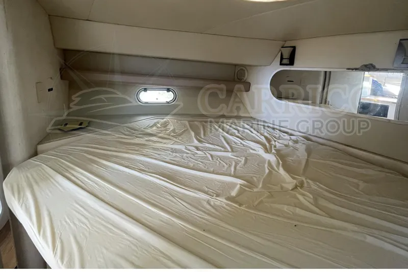 Slide: The Image of 1996 Cruisers Yachts 3650 Aft Cabin interior with bed and porthole window. - 30