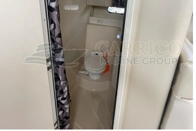Slide: The Image of 1996 Cruisers Yachts 3650 Aft Cabin bathroom with toilet and shower curtain. - 32