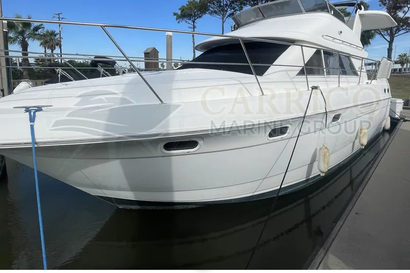 Slide: The Image of 1996 Cruisers Yachts 3650 Aft Cabin docked, showcasing sleek design and spacious deck. - 6