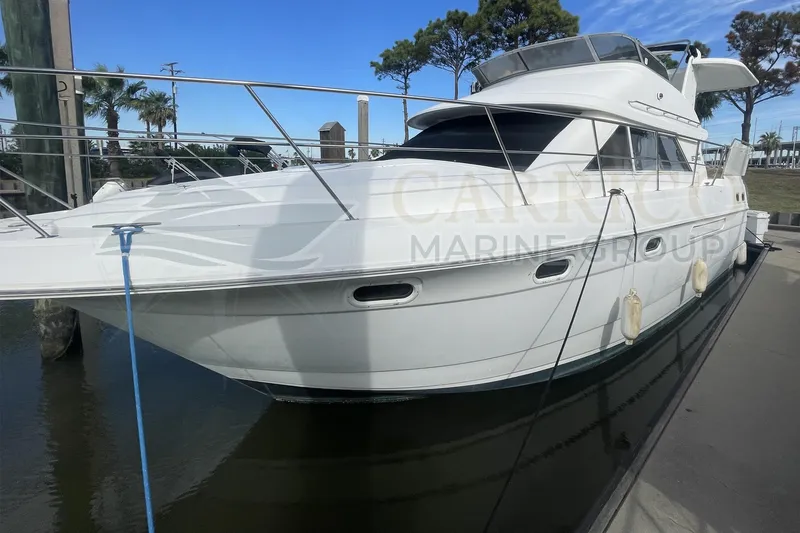 The Image of 1996 Cruisers Yachts 3650 Aft Cabin docked, showcasing sleek design and spacious deck. - 1