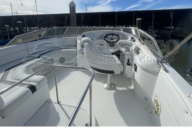 Slide: The Image of 1996 Cruisers Yachts 3650 Aft Cabin helm with seating, docked at marina. - 16