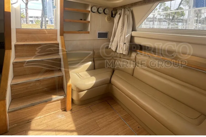 Slide: The Image of Interior of 1996 Cruisers Yachts 3650 Aft Cabin with beige seating and wooden stairs. - 21