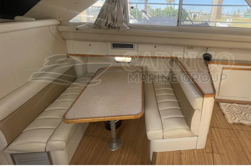 Slide: The Image of 1996 Cruisers Yachts 3650 Aft Cabin interior with dining area and seating. - 24