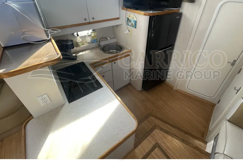 Slide: The Image of 1996 Cruisers Yachts 3650 Aft Cabin kitchen with stove, sink, and refrigerator. - 26
