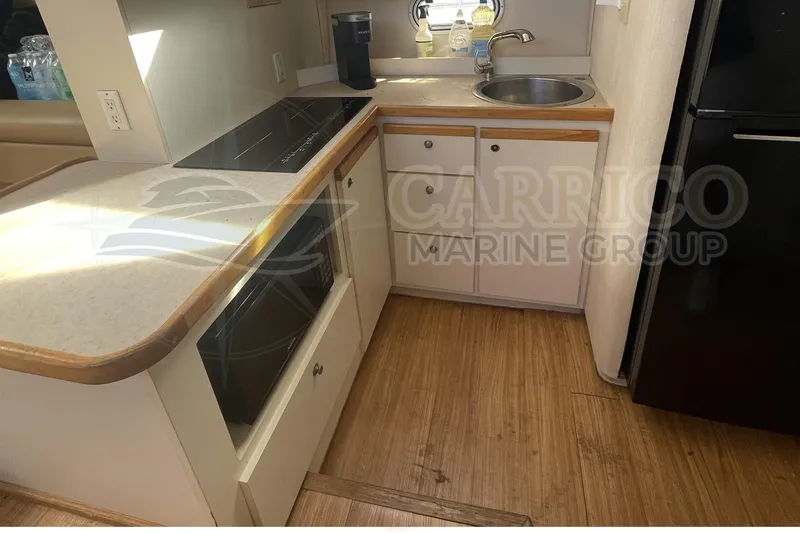 Slide: The Image of 1996 Cruisers Yachts 3650 Aft Cabin kitchen with stove, sink, and cabinetry. - 27