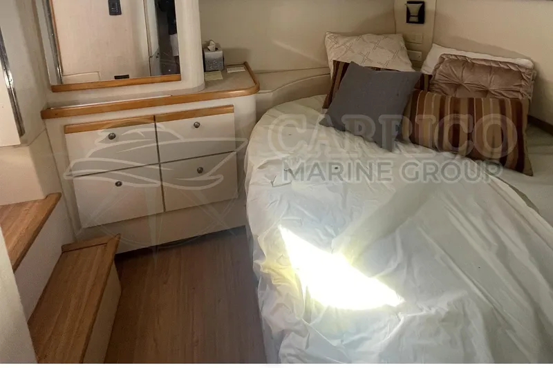 Slide: The Image of 1996 Cruisers Yachts 3650 Aft Cabin interior with bed, pillows, and wooden cabinetry. - 34