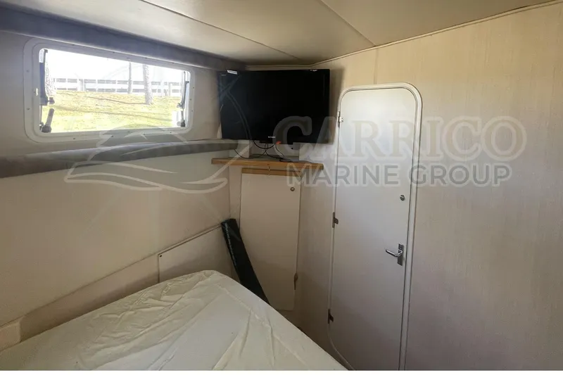 Slide: The Image of 1996 Cruisers Yachts 3650 Aft Cabin interior with bed, window, and TV. - 35