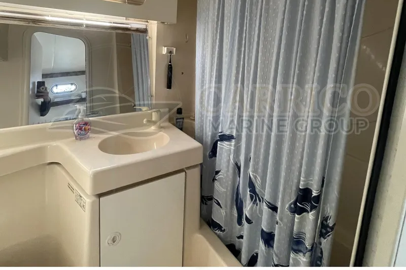 Slide: The Image of Bathroom interior of 1996 Cruisers Yachts 3650 Aft Cabin with sink and shower curtain. - 36
