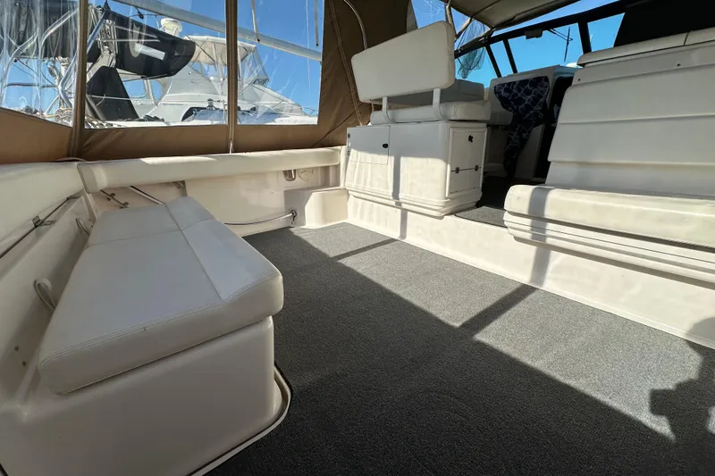 Slide: The Image of 2001 Tiara Yachts 3500 Open docked, featuring a covered deck and blue marine equipment. - 11