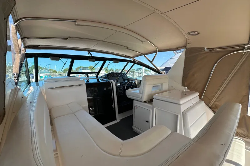 Slide: The Image of Bow of 2001 Tiara Yachts 3500 Open at marina, featuring anchor and railing. - 12