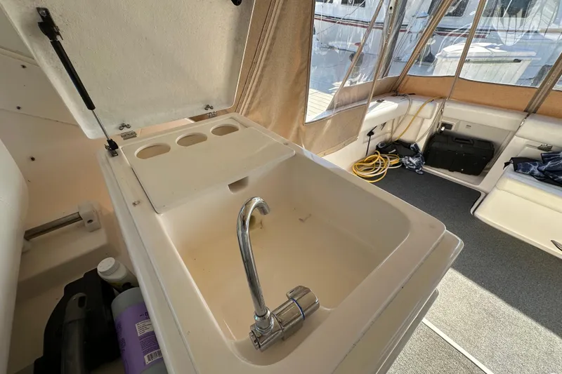 Slide: The Image of Bow of 2001 Tiara Yachts 3500 Open at marina, showcasing anchor chain and deck details. - 13