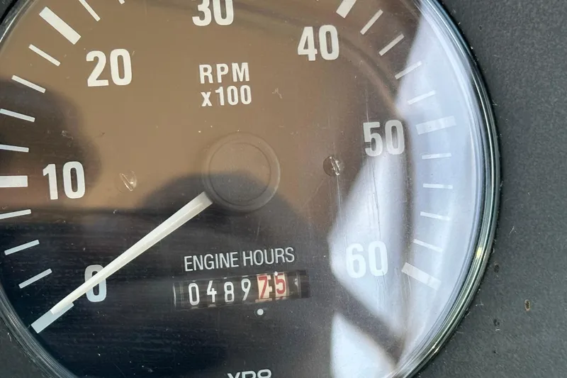 Slide: The Image of Control panel of a 2001 Tiara Yachts 3500 Open, featuring navigation instruments and steering wheel. - 18